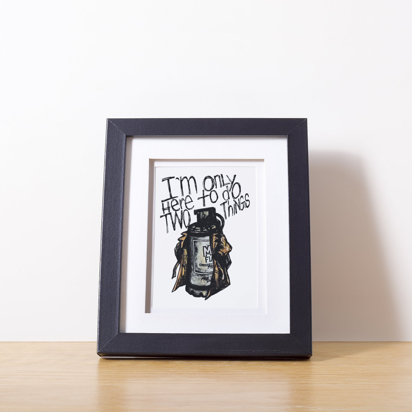 Framed artwork with a humorous quote and illustration on a white surface.