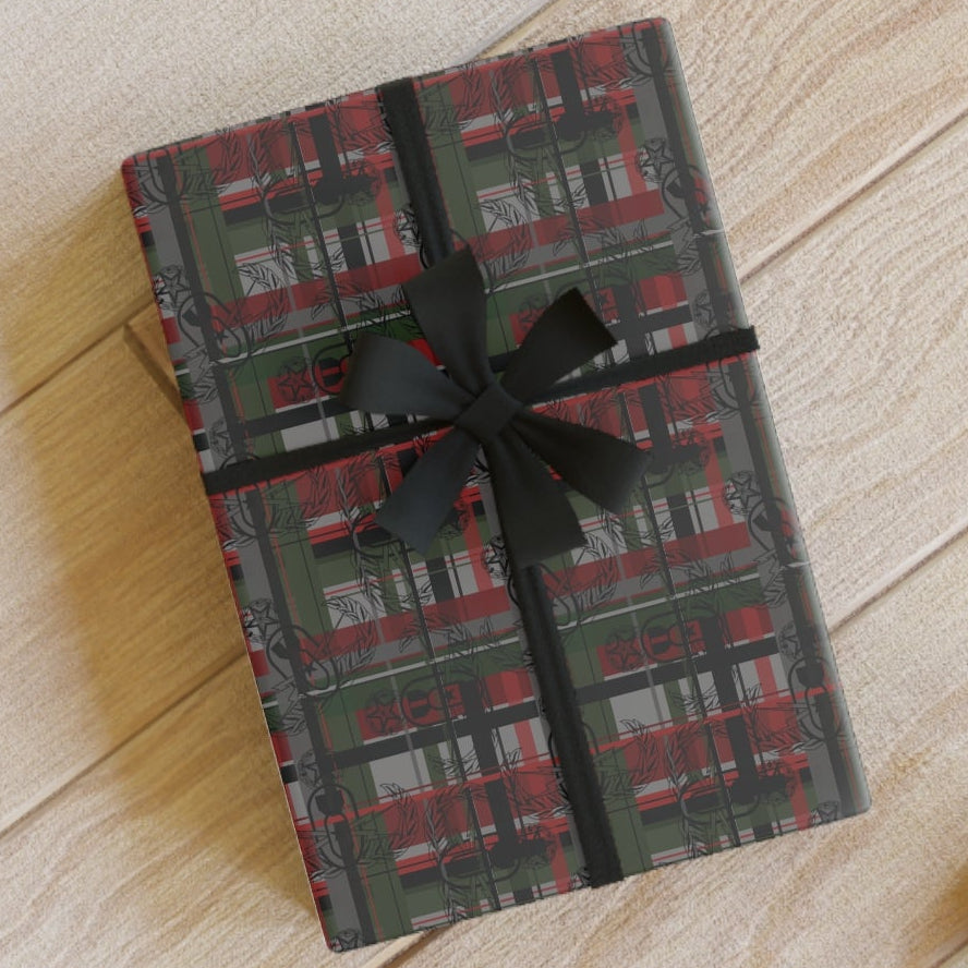 Gift wrapped in plaid paper with a black ribbon on a wooden floor.