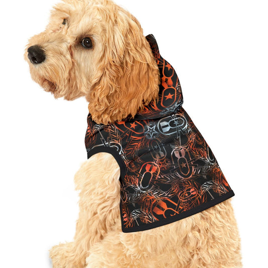 Dog wearing a black hoodie with orange and white patterns on a white background