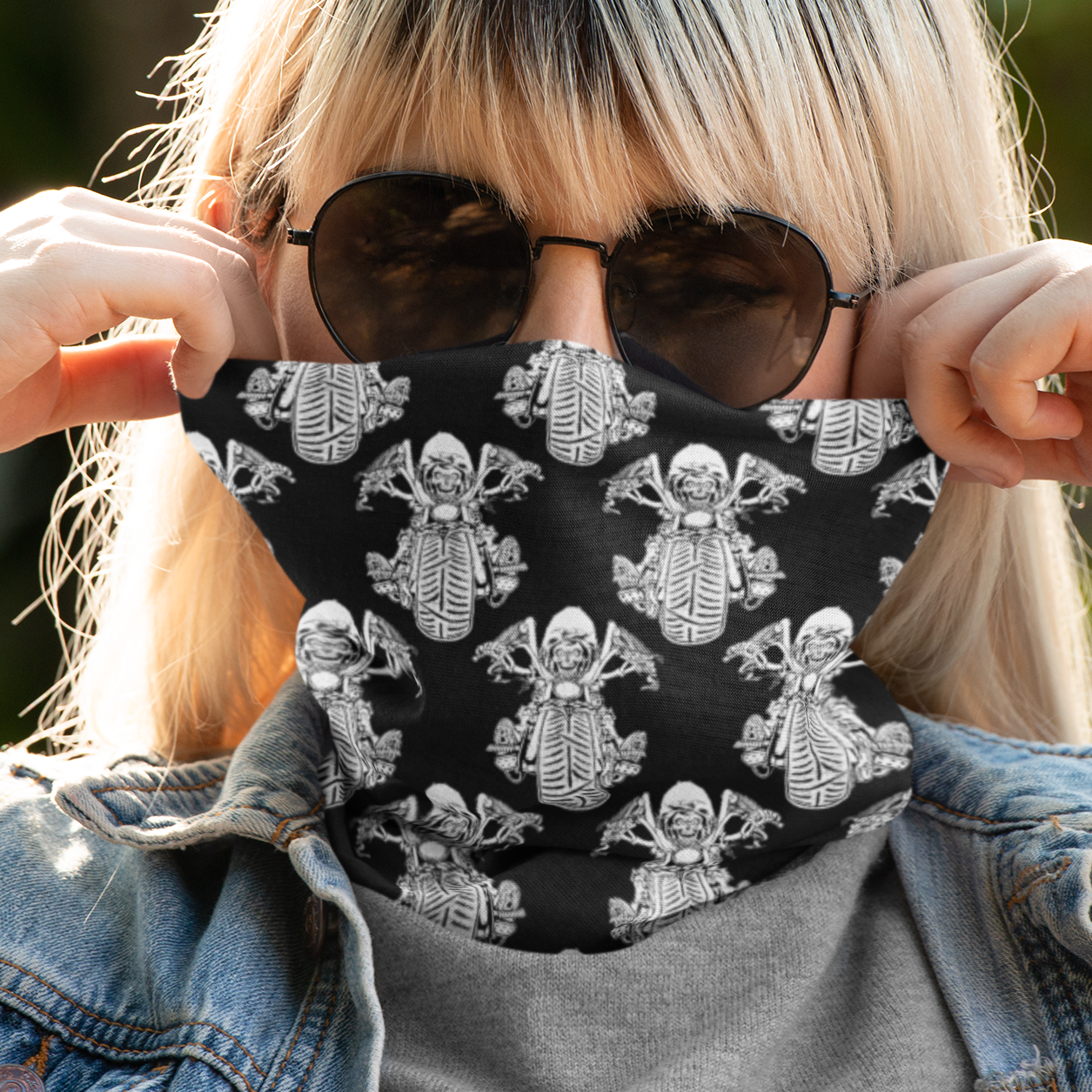 Person wearing a black face mask with white skeleton designs outdoors