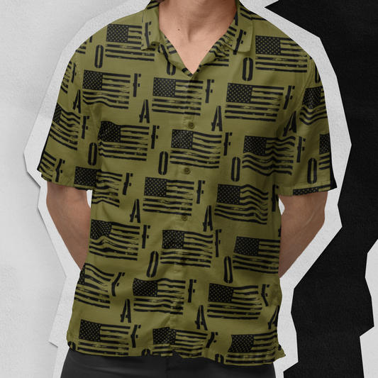 Man wearing a green patterned shirt and black shorts against a white background