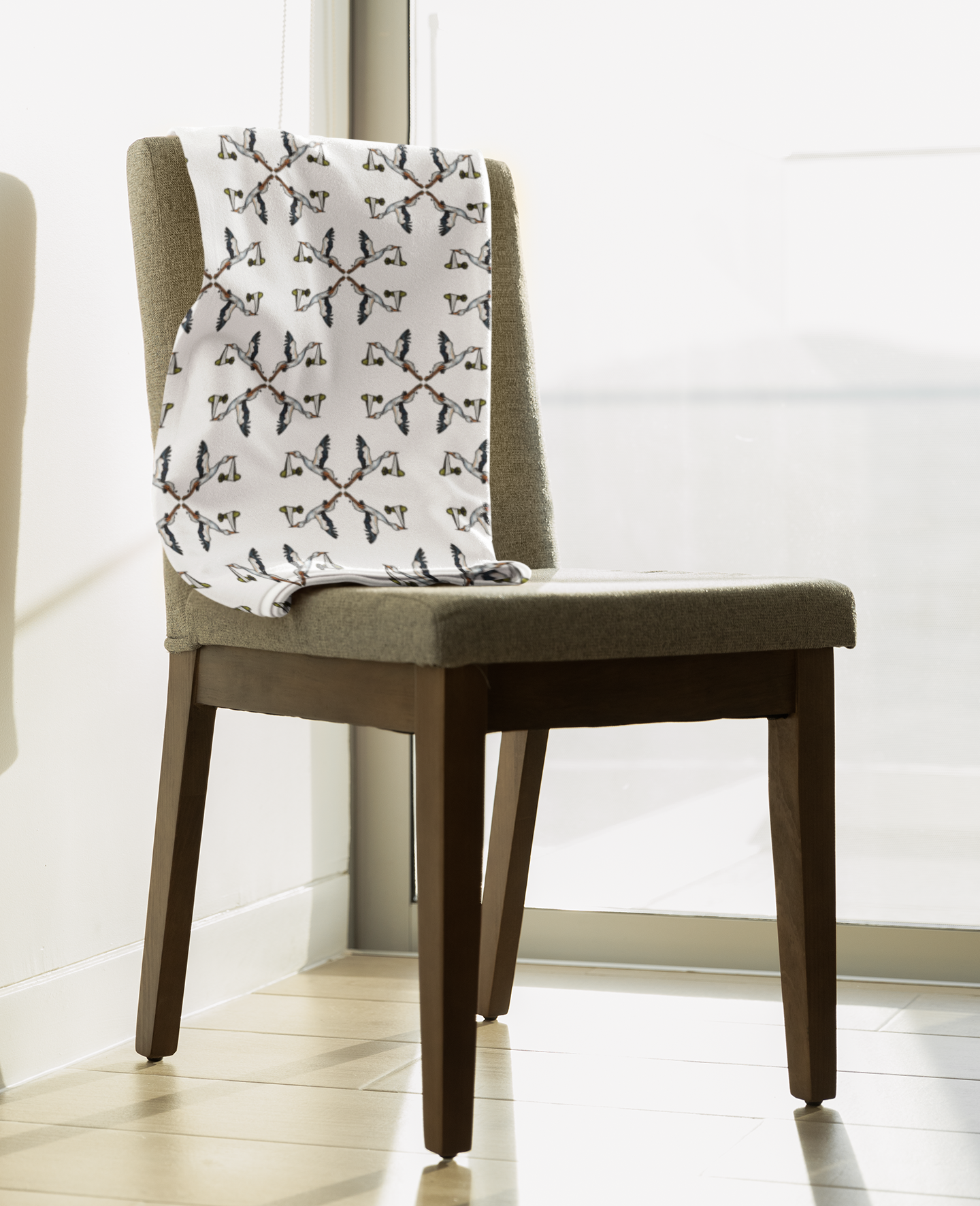 Chair with a patterned cushion in a room with a white wall and tiled floor.